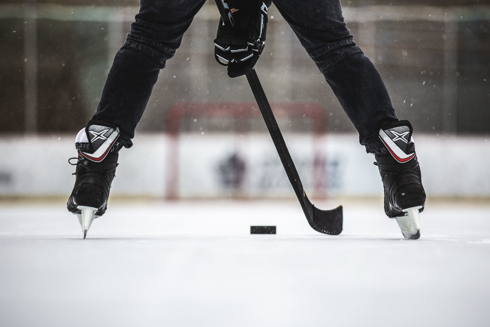 Pro stock hockey stick and puck on the ice